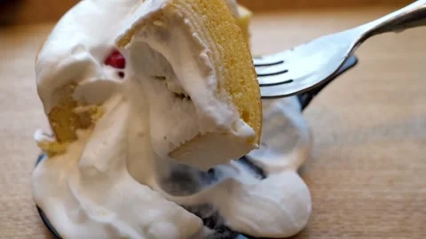 Close-up of Fork Slicing into Moist Tres Leches Cake with Whipped Cream and Stra Stock Footage 331775729