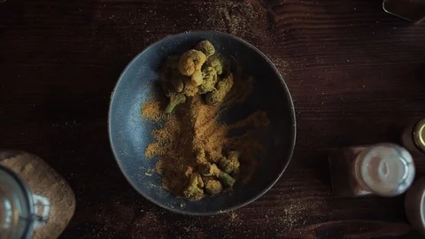 Close-up of a form spicy broccoli falling from a height into a large bowl on a Stock Footage 127568706