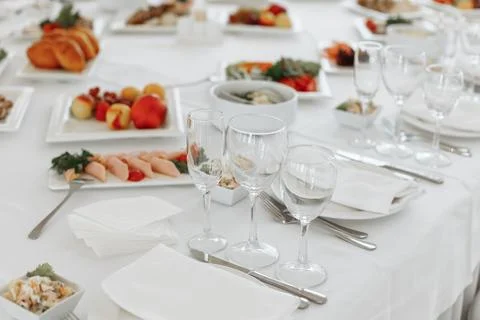 Close-up of a formal place setting with clear wine glasses, a white folded Stock Photos