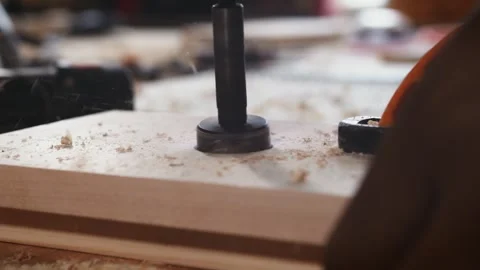 Close up of Forstner bit drilling wooden board in woodworking workshop on drill Stock Footage 340601606