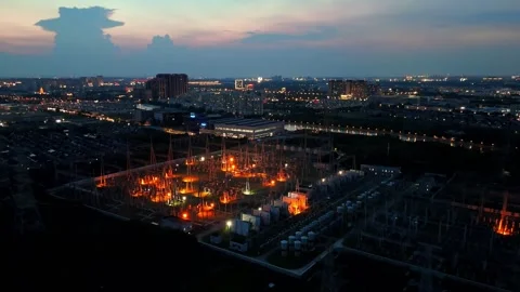 Close Forward Aerial View of Illuminated Substation at Dusk Stock Footage 342145500