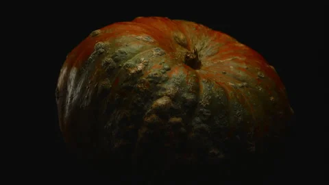 Close-up, forward movement with a turn, beautiful red pumpkin on a black Stock Footage 177454327
