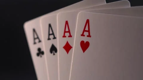 Close up of four aces on black background with smooth sliding and panning motion Stock Footage 281486799