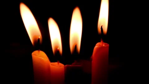 Close up of four lit candles with moving flames Stock Footage 248347291