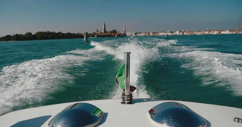 Close-up FPV view of back of motorboat with flag of Italy flying floating on the Stock Footage 220488847