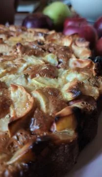 Close-up, a Fragment of Apple pie with a Golden crust. In the background, red Stock Photos
