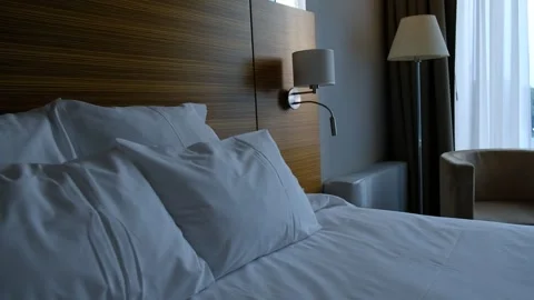 Close-up fragment of bedroom with empty bedside table, reading lamp  Stock Footage 244773477