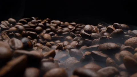 Close up of fragrant coffee beans are roasted smoke comes from coffee beans. Stock Footage 147875829