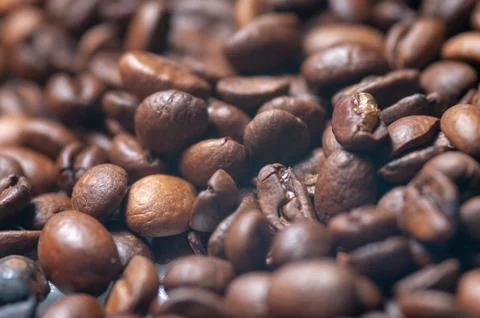 Close-up fragrant roasted coffee beans, brown saturated color Stock Photos