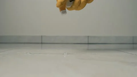 Close-up frame of a hand in yellow gloves wiping a tile with a rag on the floor Stock Footage 172573772