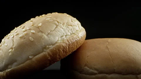 Close-up frame of small bread on a black studio background. Close-up of an Stock-Footage 138596889