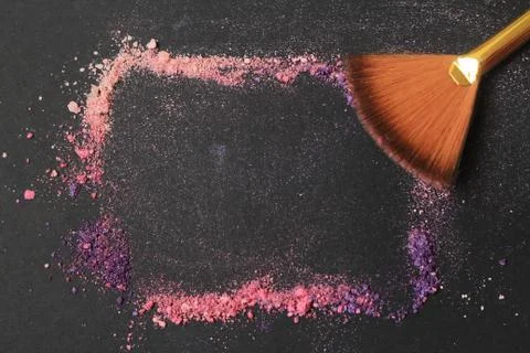Close up. frame for text with brushes for make-up and grains of dust on a black Stock Photos