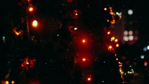 Close up frame, while it's snowing outside, Christmas decor outside in the city. Video stock 145199136