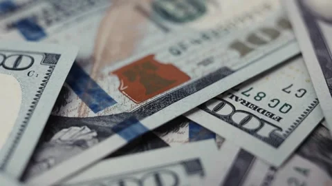 Close-up frames of US dollar banknotes stacked together, showcasing intricate Stock Footage 327695397