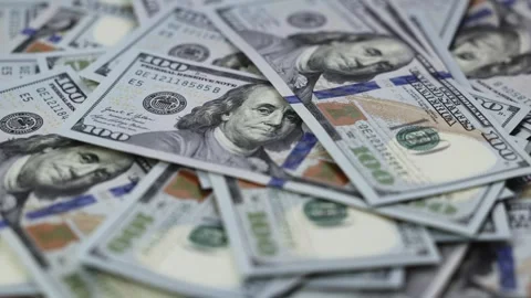 Close-up frames of US dollar banknotes stacked together, showcasing intricate Stock Footage 327698856