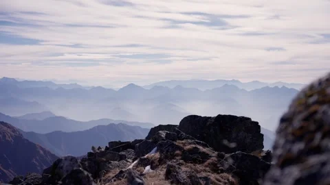 Close framing of a lichen covered boulder in soft focus foreground against hazy Stock Footage 344179926