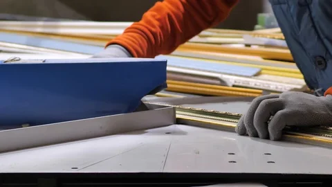 Close-up. Framing Workshop. A man makes a frame for a picture made of beads Stock Footage 128738260