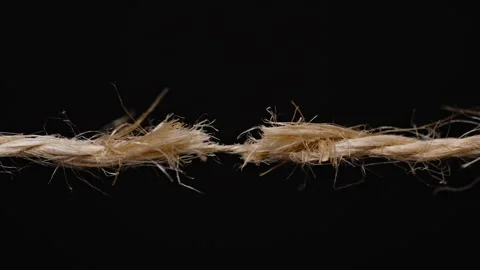 Close-up of a frayed rope on the verge of snapping, showing tension and stress Stock Footage 296087325
