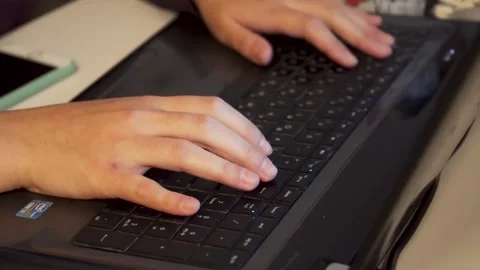 Close-up of a freelance developer's hands typing program code on a laptop keyboa Stock Footage 253391880