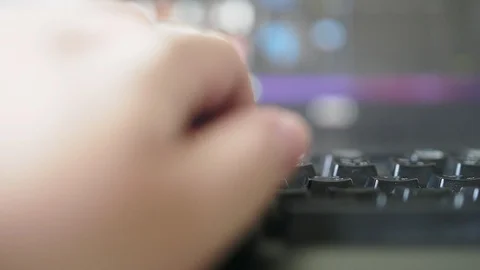 Close up of freelance hand working on backlit keyboard with video editing Vidéo 102177496
