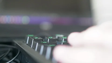 Close up of freelance hand working on backlit keyboard on video editing software Stock Footage 102178596