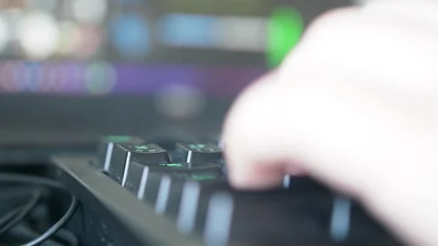 Close up of freelance hand working on backlit keyboard on video editing software Видео 102178683