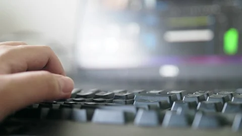 Close up of freelance hand working on backlit keyboard on video editing program Vidéo 102179074