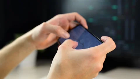 Close-up of freelancer analyzing stock exchange chart using mobile app Видео 166431776