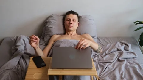 Close up of freelancer closing laptop and stretching happily after finishing Stock Footage 314515498
