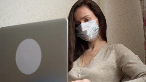 Close up freelancer in mask using laptop, remote working at home. Pandemic time Stock Footage 128553066