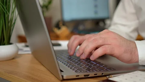 Close up of freelancer's developer hands typing program code on laptop keyboard Stock Footage 277393370
