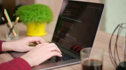 Close up of freelancer's hands typing code on laptop keyboard. Camera slides Stock Footage 219603118