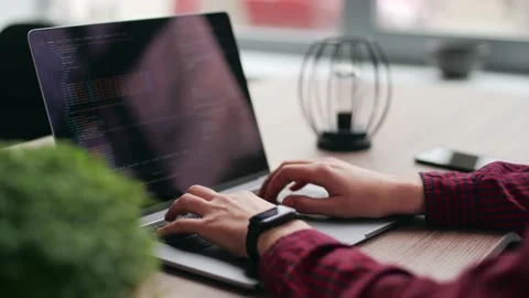 Close up of freelancer's hands typing code on laptop keyboard. Camera slides Video stock 220072803
