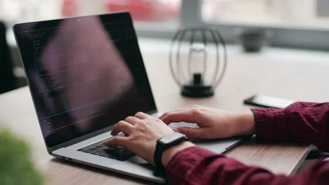 Close up of freelancer's hands typing code on laptop keyboard. Camera slides Stock Footage 220725232