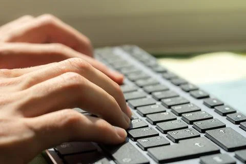 Close-up of a freelancers hands typing on a computer keyboard, productivity.. Stock Photos