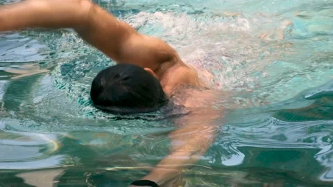 Close-up of freestyle swimmer in a pool in clear blue water. Professional athlet 動画素材 194102264