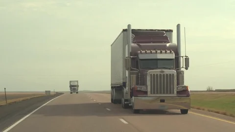 CLOSE UP: Freight container semi truck speeding along the Great Plains highway Stock Footage 76432304