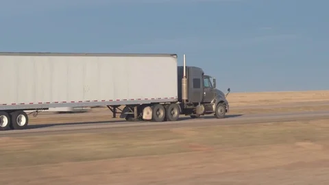 CLOSE UP: Freight container semi truck speeding along the busy rural highway Stock Footage 76433109