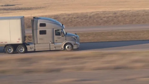 CLOSE UP: Freight container semi truck hauling goods along the rural highway 스톡 동영상 76433210
