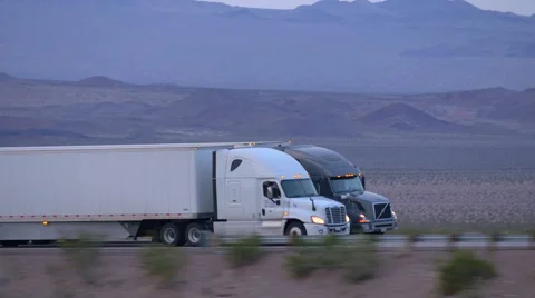CLOSE UP: Freight semi truck driving and transporting goods on busy highway Stock Footage