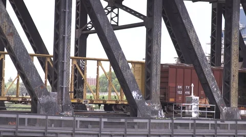 Close Up freight train cars going across bridge Stock Footage 64912357