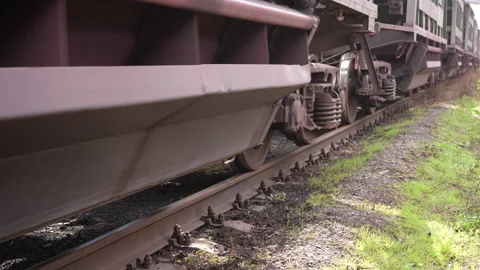 Close-up of freight train rolling stock. Loaded hopper cars moving. Stock Footage 307170296