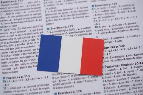 Close up of French flag on language learning book Stock Photos