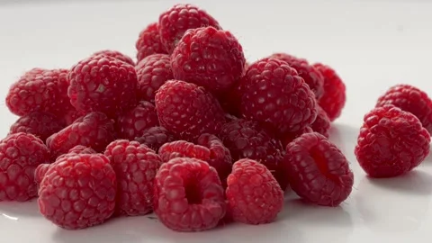 A Close-Up Of Fresh And Tasty Raspberry Rotating. Isolated, On White Background. Stock Footage 237606432