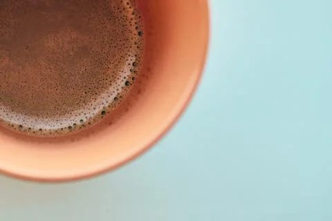 Close-up of fresh aromatic hot coffee with crema in a ceramic cup on light .. Stock Photos