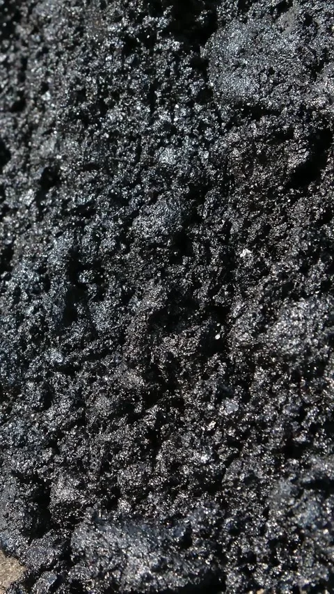 Close-up, fresh asphalt in the process of laying on the road,, large lumps, in Video stock 318347489