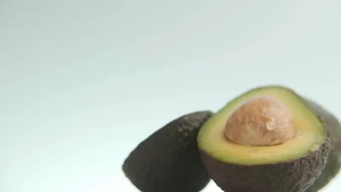 Close-up of fresh avocado fruit on cyan background Stock Footage 246348490