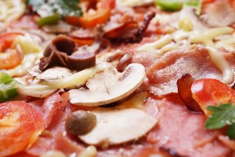 Close up of fresh baked pizza with prosciutto and bacon Stock Photos