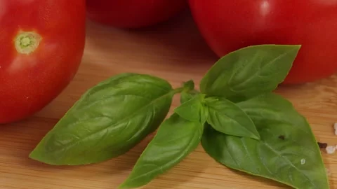 Close-up of fresh basil on ripe tomatoes. Stock Footage 340329444