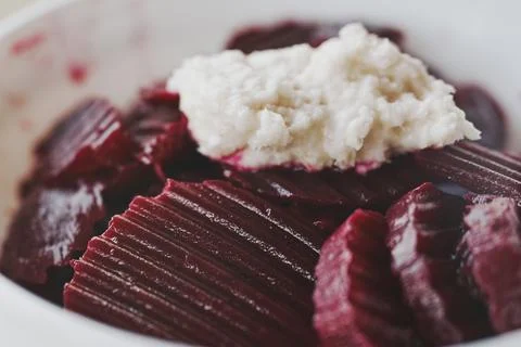 Close-up of fresh boiled beetroot salad topped with spicy grated horseradis.. Stock Photos